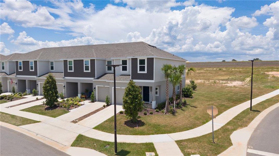 Front exterior of a new home in Waterstone, Groveland, FL, highlighting curb appeal (Image 22).