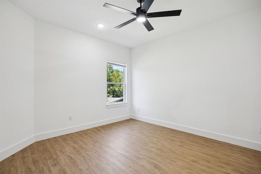 Spare room featuring wood finished floors, recessed lighting, and ceiling fan