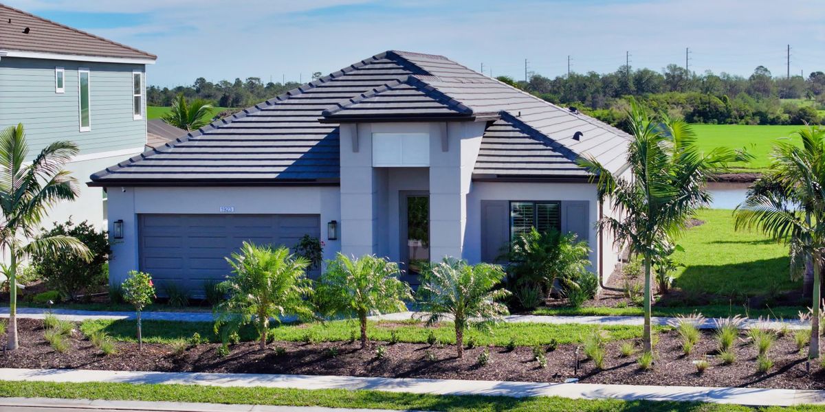 Front exterior of a new home in Palm Grove, Lakewood Ranch, FL, highlighting curb appeal (Image 24).