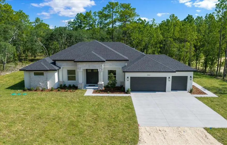 Front exterior of a new home in , Weeki Wachee, FL, highlighting curb appeal (Image 30). Front exterior of a new home in , Weeki Wachee, FL, highlighting curb appeal (Image 30).