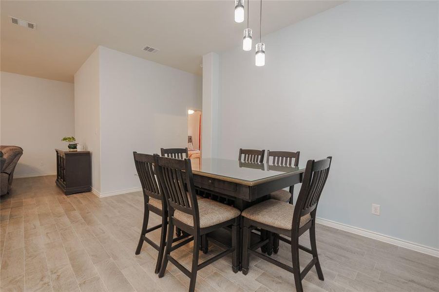 Dining space with light hardwood / wood-style flooring