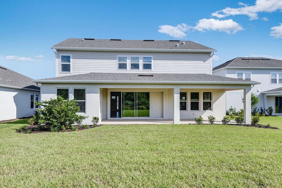 Exterior details and patio area of a home in Ardisia Park, New Smyrna Beach (Image 4).