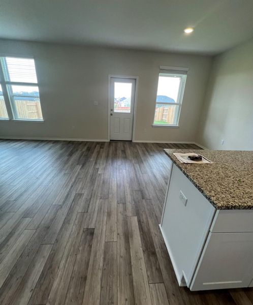 Granite counters complement the rich wood flooring in this versatile dining space.