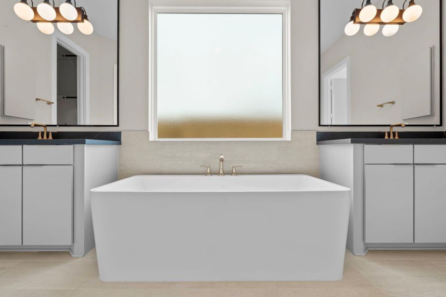The main suite is beautifully appointed with high-end finishes and a soaker tub