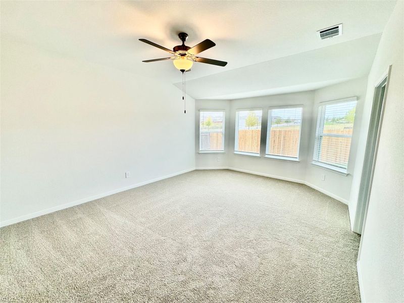 Empty room with carpet floors and a ceiling fan