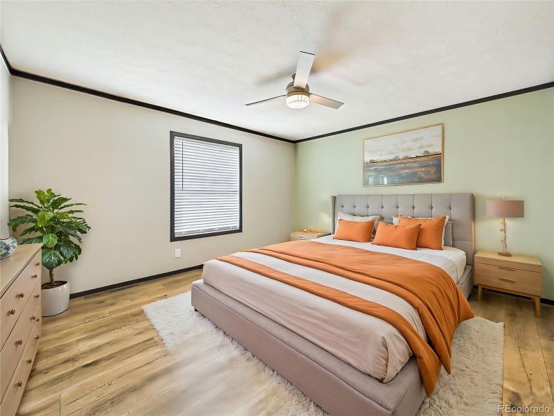 (Virtually Staged) – Staged bedroom highlighting a relaxed and comfortable atmosphere with coordinated furnishings and soft tones.