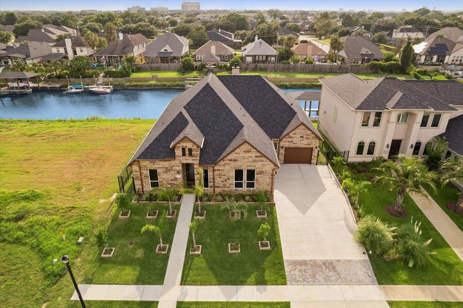 Front exterior of a new home in , Kemah, TX, highlighting curb appeal (Image 26). Front exterior of a new home in , Kemah, TX, highlighting curb appeal (Image 26).
