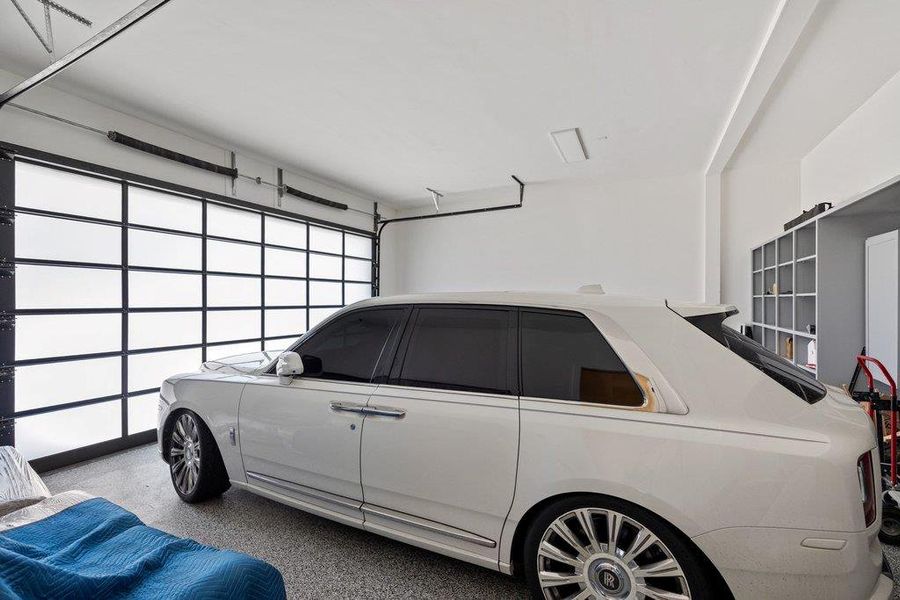 Secure parking within a meticulously maintained garage, offering ample space and pristine flooring.