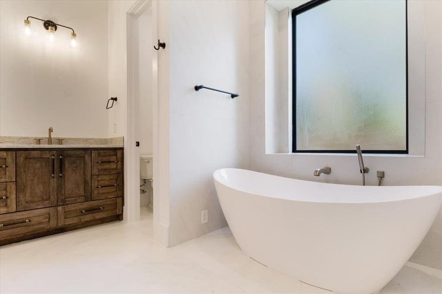 Bathroom with vanity, toilet, and tile floors