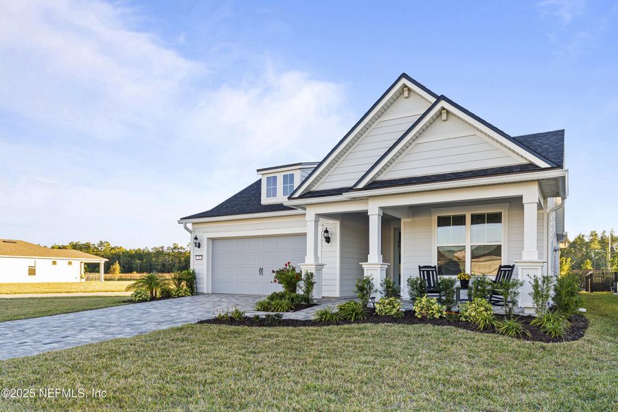 Front exterior of a new home in Summer Bay at Grand Oaks, St. Augustine, FL, highlighting curb appeal (Image 1).