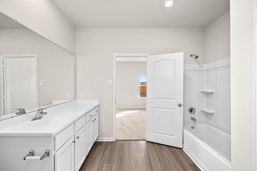 Luxurious primary bathroom with a walk-in closet.