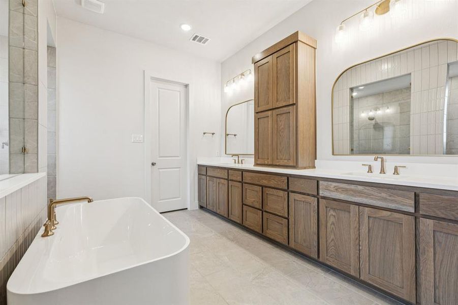 You'll enjoy fantastic storage and ample room for two in this delightful owner's bath!