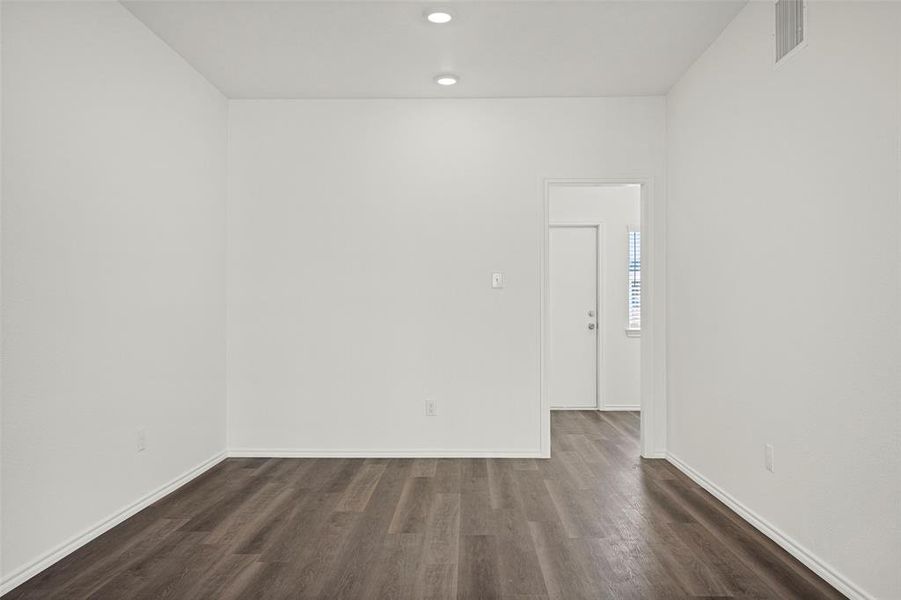 Spare room featuring dark hardwood / wood-style floors