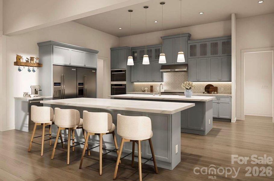 This gourmet kitchen is a perfect blend of style and functionality. It features soft blue-gray custom cabinetry, sleek quartz countertops, and a double island layout that offers ample space for meal prep and casual dining This gourmet kitchen is a perfect blend of style and functionality. It features soft blue-gray custom cabinetry, sleek quartz countertops, and a double island layout that offers ample space for meal prep and casual dining