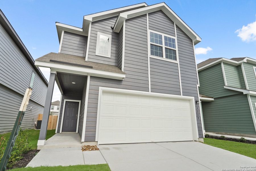 Front exterior of a new home in Melissa Ranch, San Antonio, TX, highlighting curb appeal (Image 18).