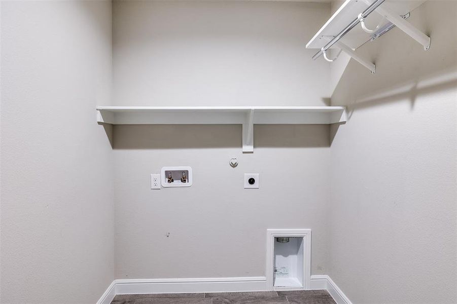 Laundry area with gas dryer hookup, washer hookup, and electric dryer hookup Laundry area with gas dryer hookup, washer hookup, and electric dryer hookup