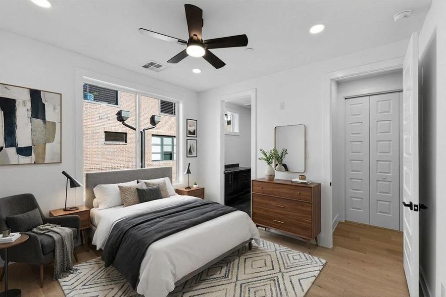 Bedroom featuring light wood-style flooring, ceiling fan, recessed lighting, and connected bathroom