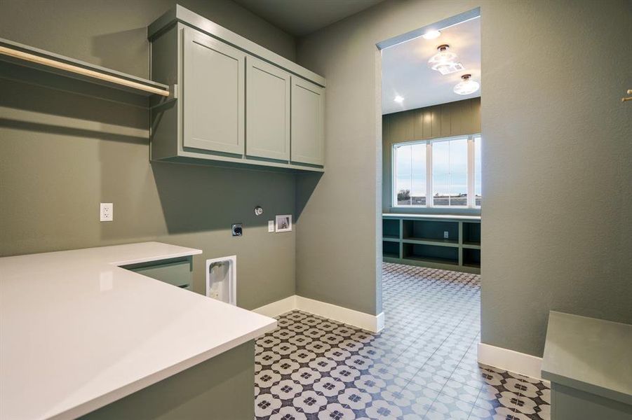 Laundry area with electric dryer hookup, cabinets, and hookup for a washing machine