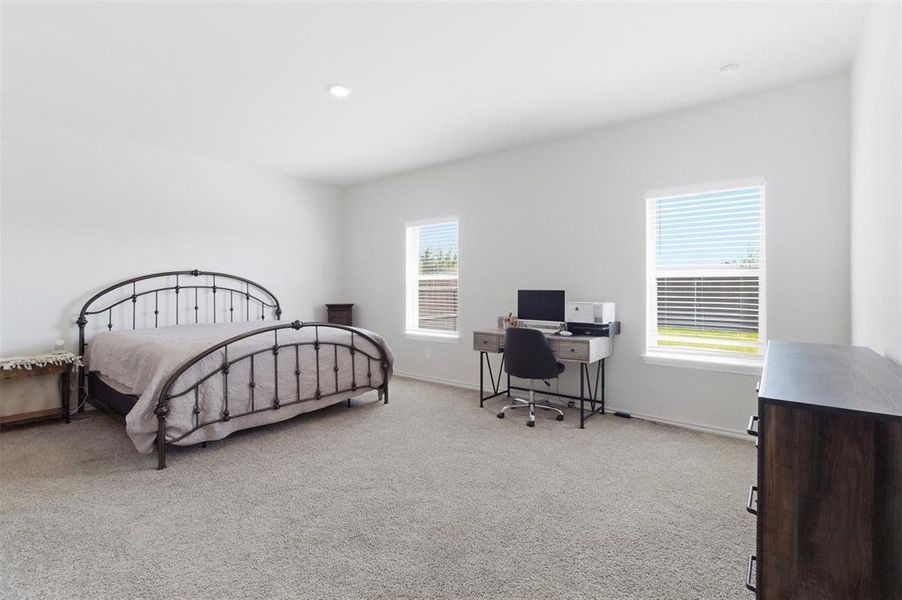 Bedroom with a desk and light carpet Bedroom with a desk and light carpet