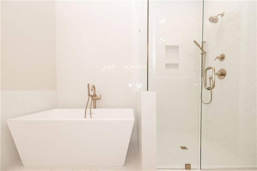 Full bathroom featuring tile walls, a soaking tub, and a stall shower Full bathroom featuring tile walls, a soaking tub, and a stall shower