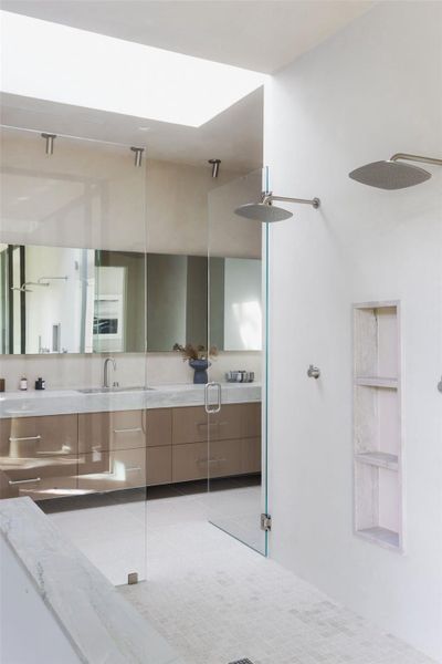 Full bath with double vanity and a walk in shower