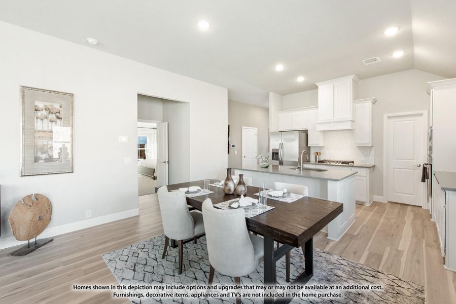 Open dining area with dark wood table and white kitchen with island in background Open dining area with dark wood table and white kitchen with island in background