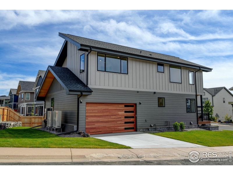 Spacious oversized garage with workshop area and large storage closet.