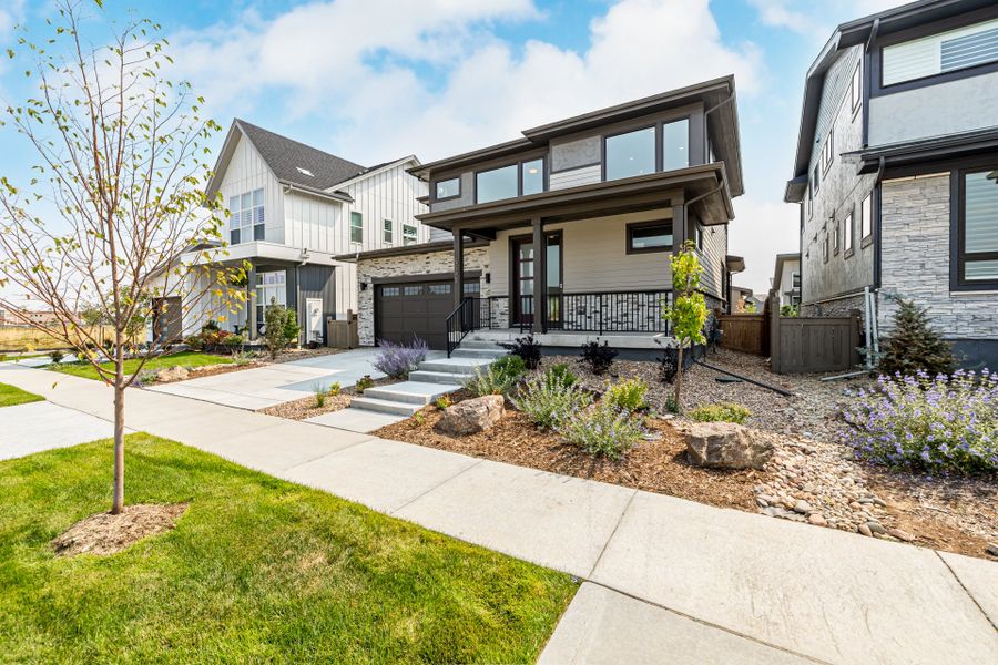 Front exterior of a new home in West Grange, Longmont, CO, highlighting curb appeal (Image 24).