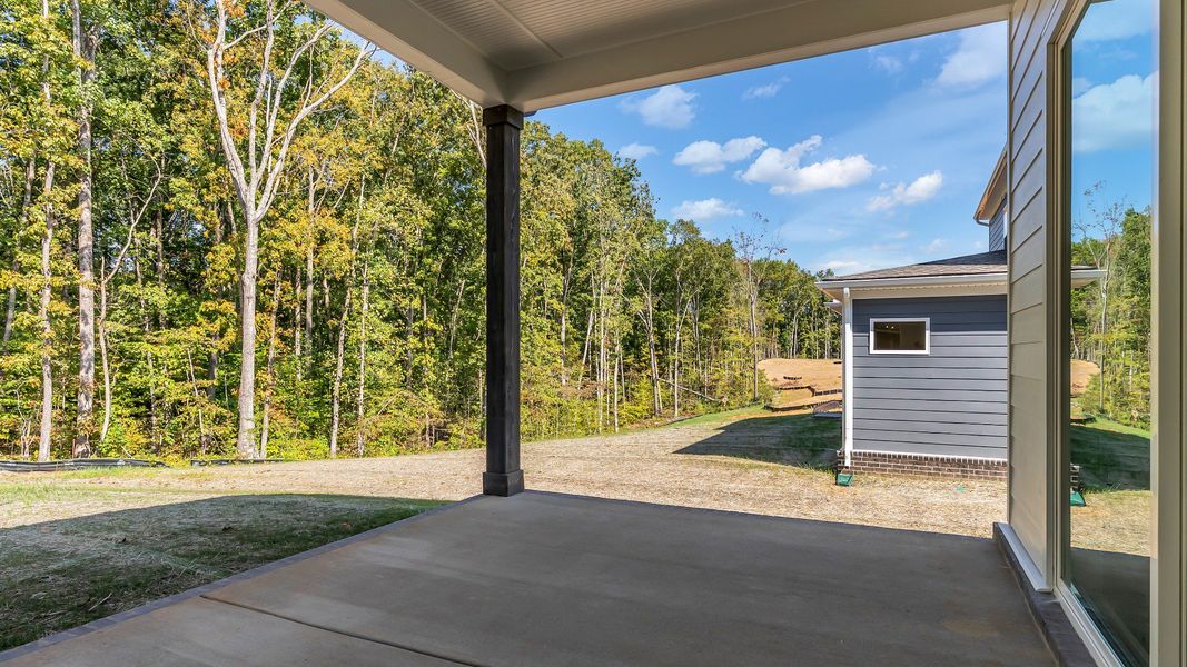 Exterior of home with covered rear porch (Representative of finished home)