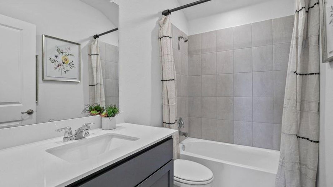Full bath featuring vanity and shower / tub combo with curtain