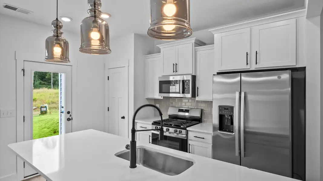 Notable 9-foot island provides generous prep and gathering space in this thoughtfully designed kitchen