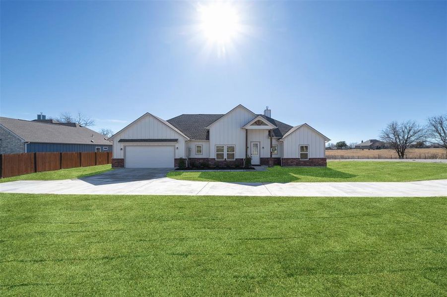 View of front facade with a garage and a front yard