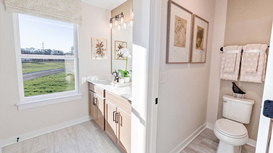 Bathroom with dual vanity and window