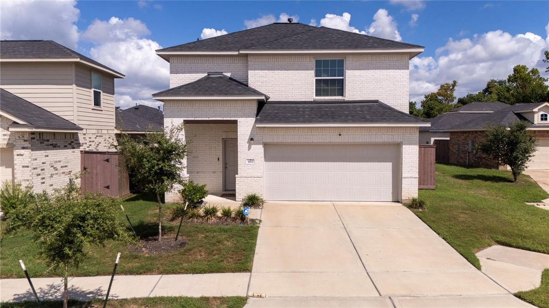 Front exterior of a new home in Woodshore, Clute, TX, highlighting curb appeal (Image 21).