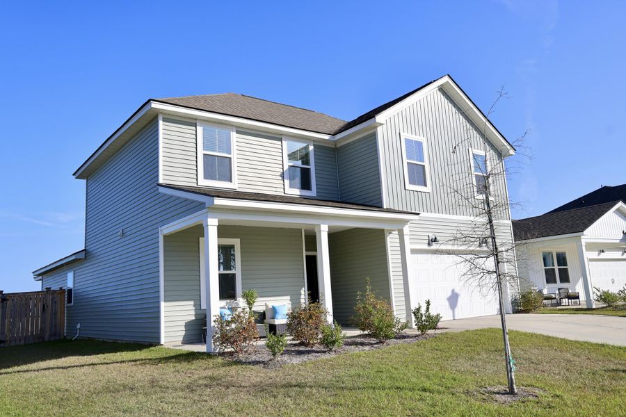 Front exterior of a new home in Sanctuary Cove at Cane Bay, Summerville, SC, highlighting curb appeal (Image 21).