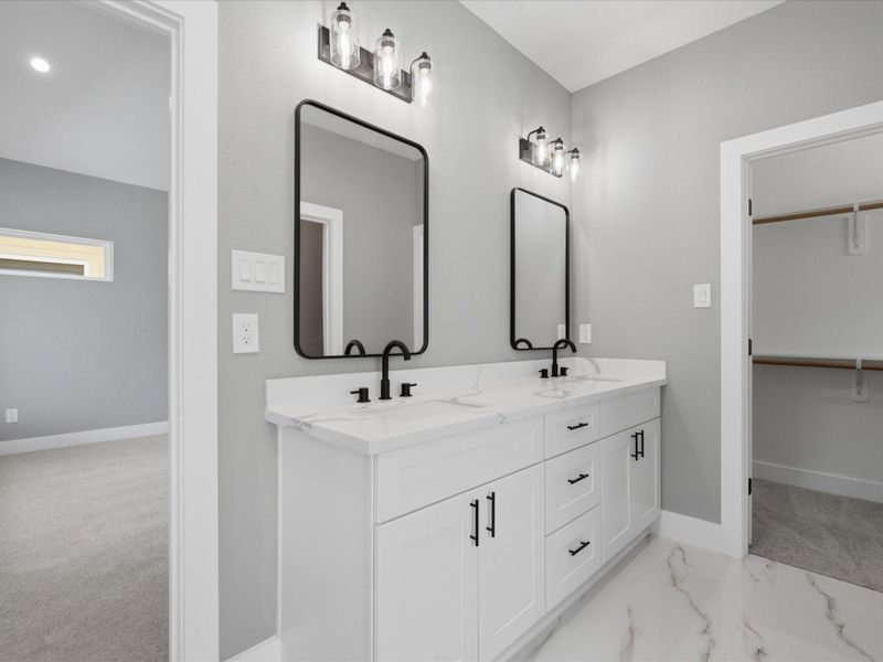 Dual vanities, a soaking tub, and a separate walk-in shower create a bath designed for both comfort and convenience. Dual vanities, a soaking tub, and a separate walk-in shower create a bath designed for both comfort and convenience.