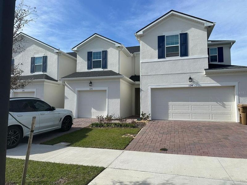Front exterior of a new home in , Kissimmee, FL, highlighting curb appeal (Image 2).