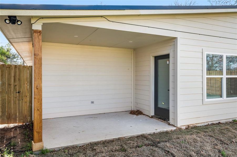 View of exterior entry featuring a patio area