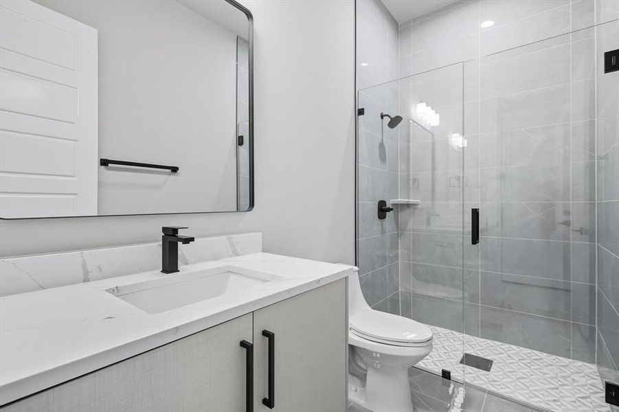 Bathroom featuring vanity, a shower stall, and tile patterned floors