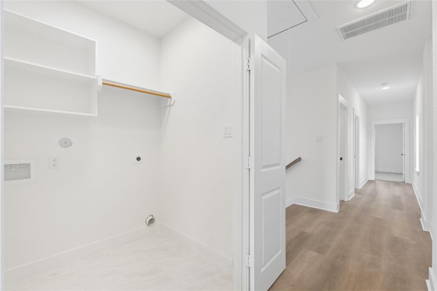 This dedicated laundry room makes everyday tasks easier, with built-in shelving for organization and space for full-size washer and dryer units. Conveniently located, it’s designed to keep the home running smoothly while offering plenty of storage to keep your things tidy! This dedicated laundry room makes everyday tasks easier, with built-in shelving for organization and space for full-size washer and dryer units. Conveniently located, it’s designed to keep the home running smoothly while offering plenty of storage to keep your things tidy!