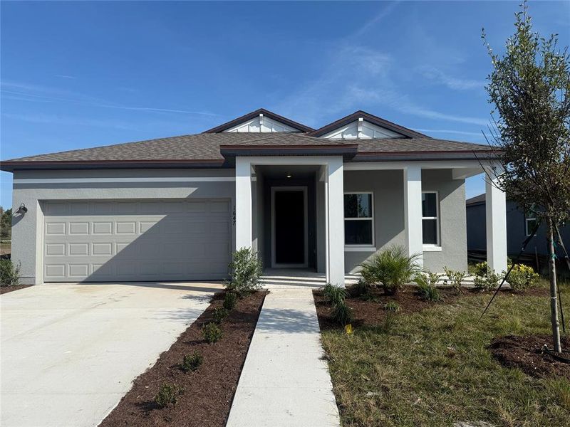 Front exterior of a new home in Tyson Reserve, St. Cloud, FL, highlighting curb appeal (Image 15). Front exterior of a new home in Tyson Reserve, St. Cloud, FL, highlighting curb appeal (Image 15).