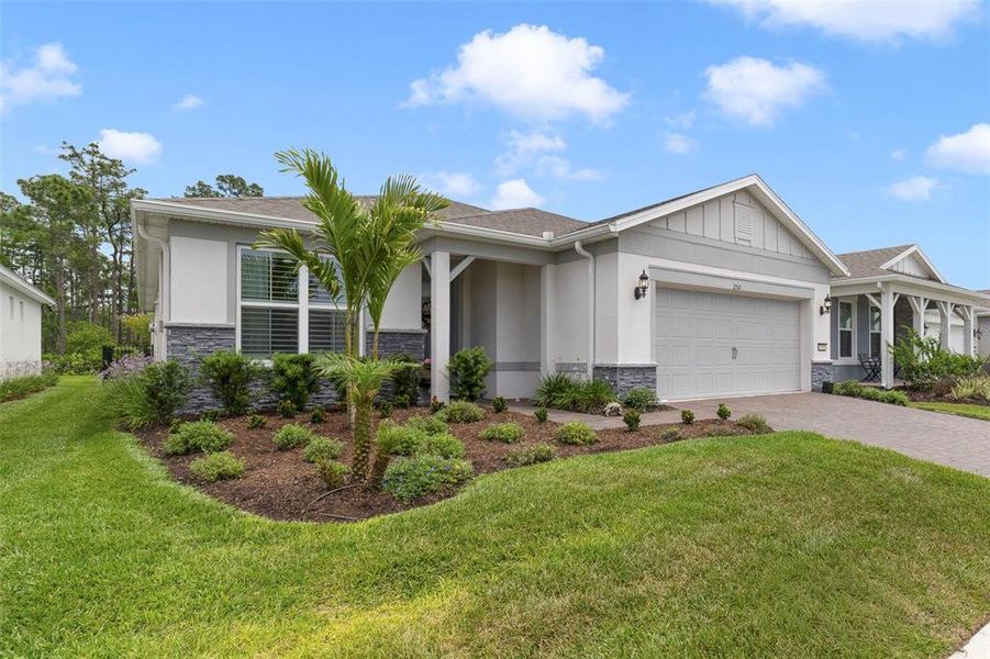 Front exterior of a new home in Del Webb Sunbridge, St. Cloud, FL, highlighting curb appeal (Image 21).