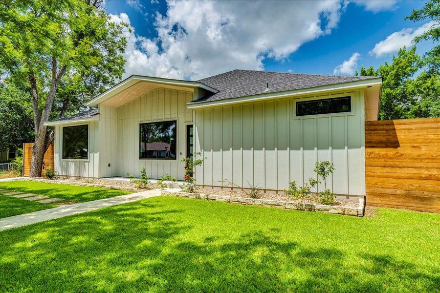 Another angle of front of property  showcasing yard