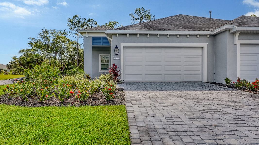 Front exterior of a new home in Wildleaf Real Estate and Homes for Sale in Parrish, FL - Neal Communities, Parrish, FL, highlighting curb appeal (Image 1). Front exterior of a new home in Wildleaf Real Estate and Homes for Sale in Parrish, FL - Neal Communities, Parrish, FL, highlighting curb appeal (Image 1).