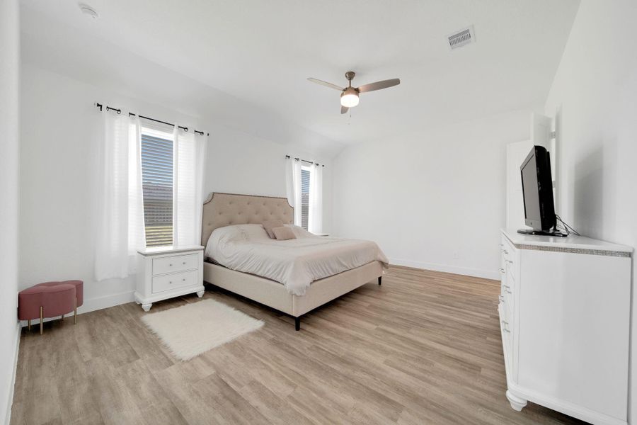 The primary suite offers ample space for a cozy sitting area and includes its own ensuite bath and walk-in closet.