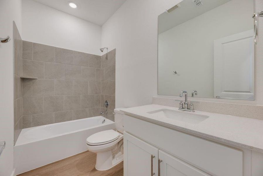 Full bath with vanity, wood finished floors, and tub / shower combination