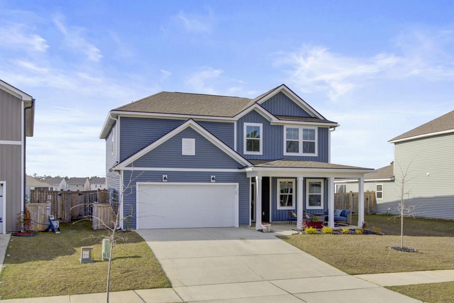 Front exterior of a new home in Sanctuary Cove at Cane Bay, Summerville, SC, highlighting curb appeal (Image 22).
