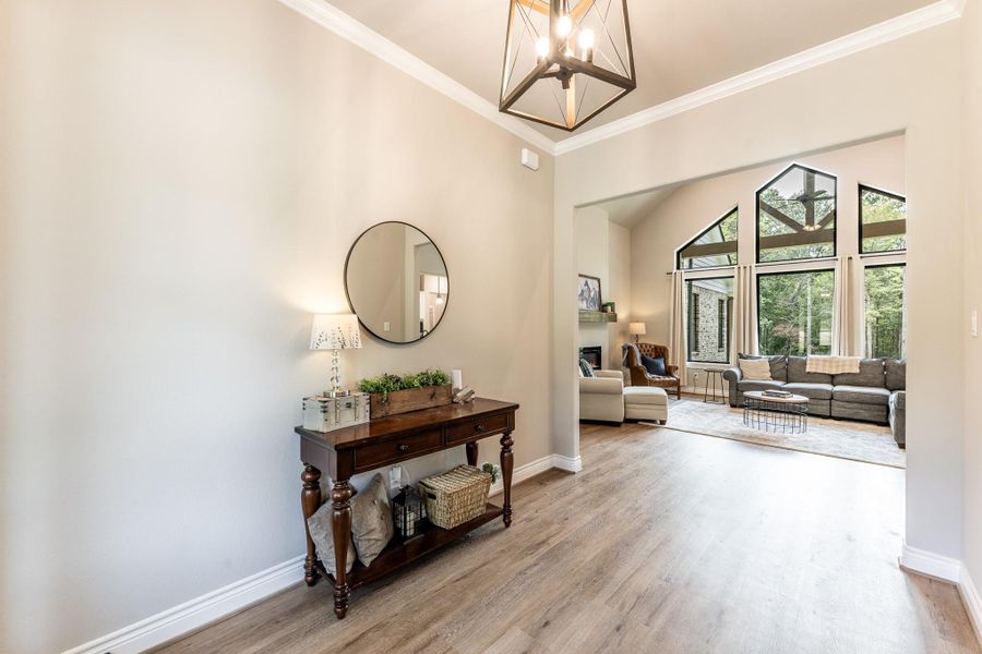 Enter to view of vaulted windows and beautiful vinyl plank flooring