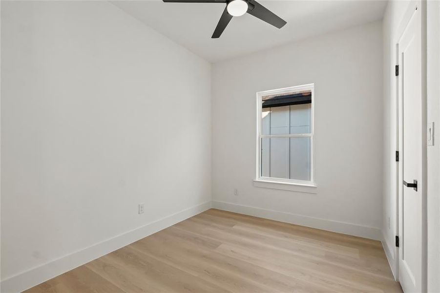 Unfurnished bedroom featuring light wood-type flooring and a ceiling fan