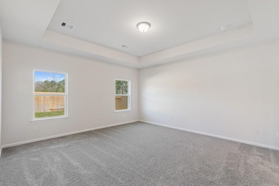The Crawford- Primary Suite with Tray Ceiling. Home under construction, photo used for illustrative purposes only, colors and options will vary.